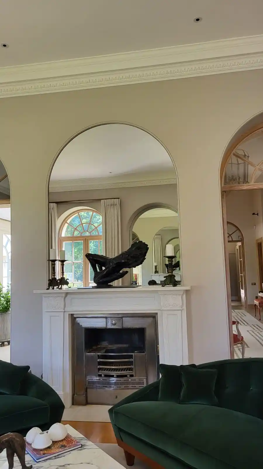 Bespoke arched mirror above fireplace by Bucks Glazing