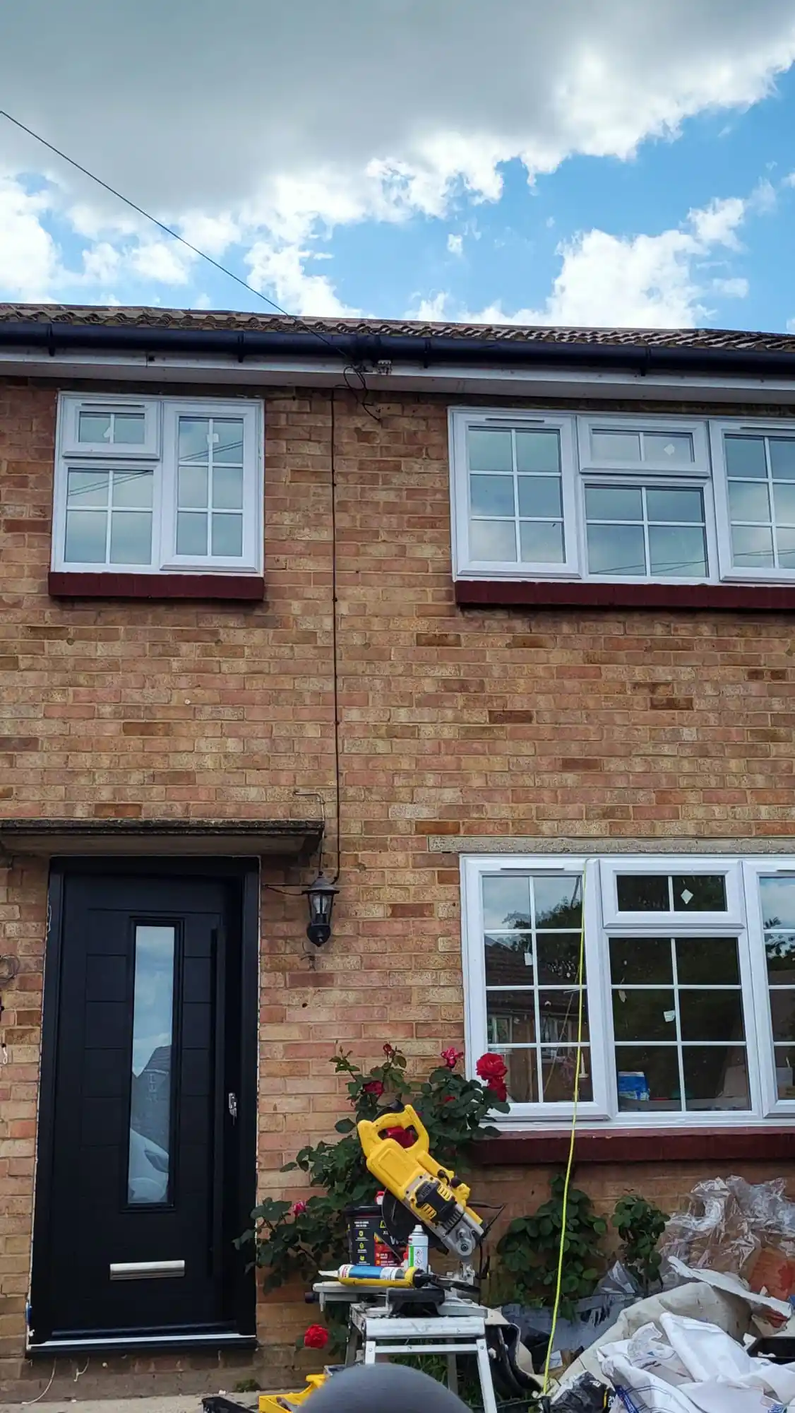 Black composite front door with UPVC windows fitted by Bucks Glazing