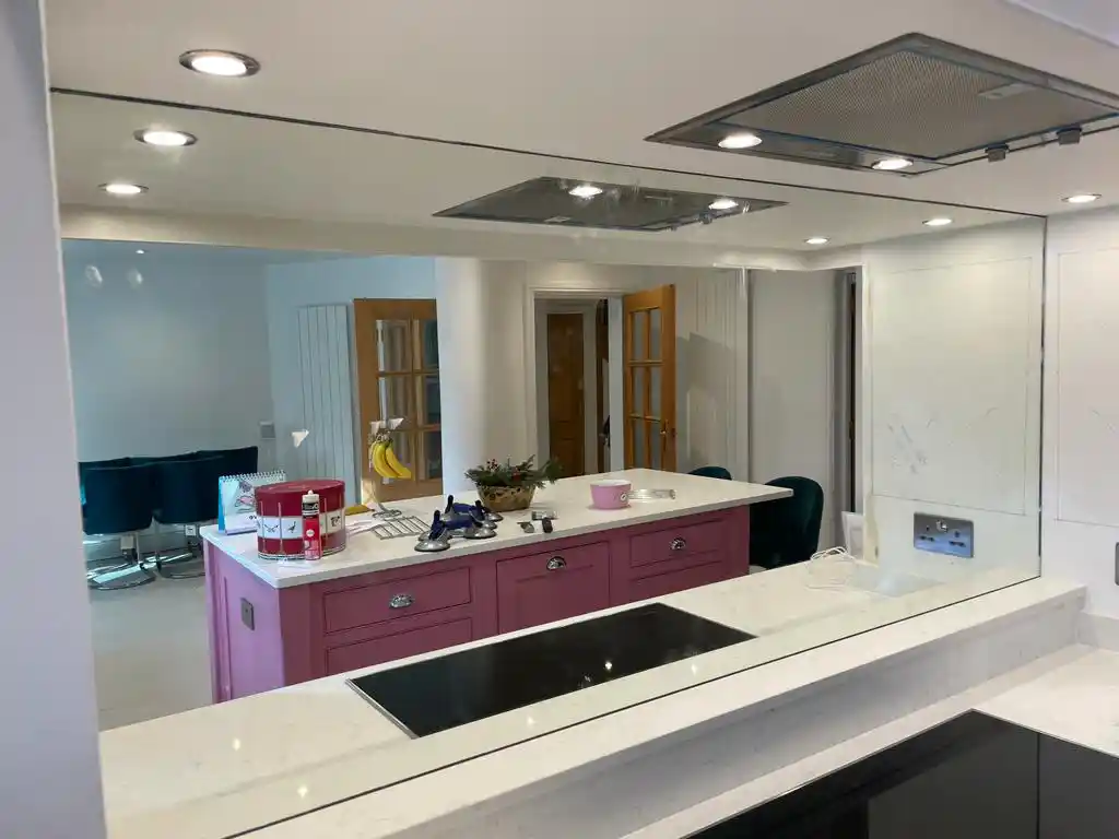 Mirror splashback behind kitchen island by Bucks Glazing