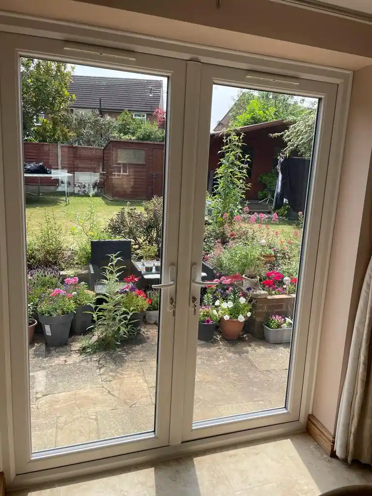 UPVC French doors opening to a garden, installed by Bucks Glazing