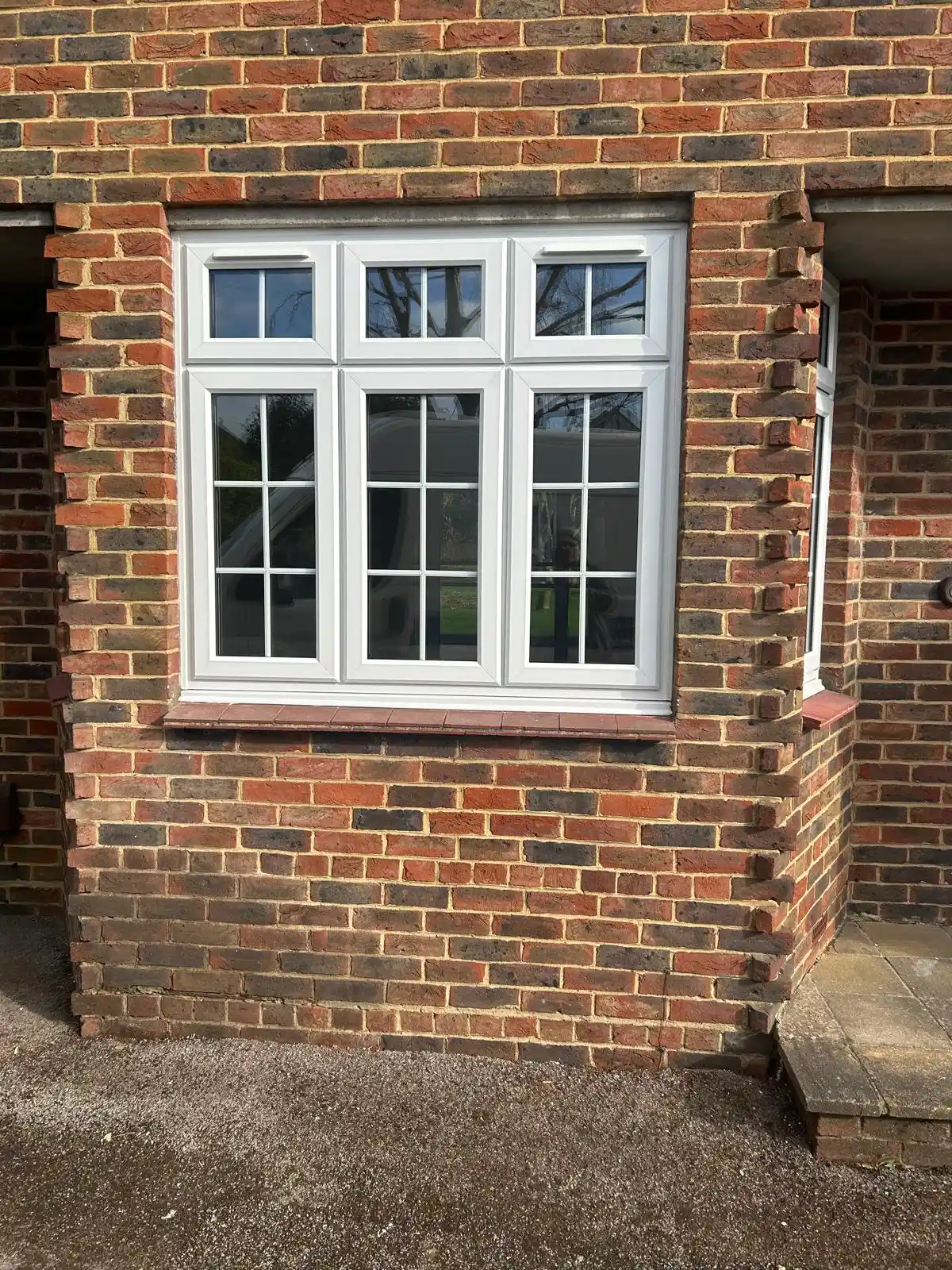 UPVC triple-pane Georgian bar window in brick property by Bucks Glazing